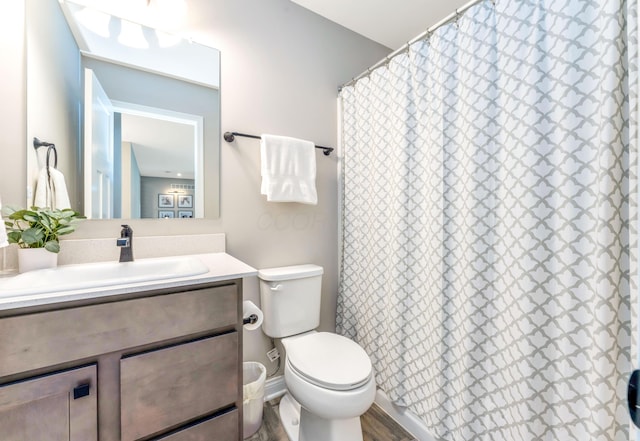 full bathroom with a shower with shower curtain, toilet, and vanity