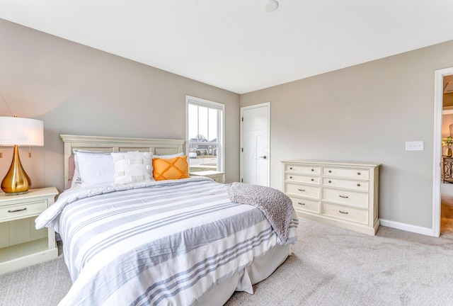 bedroom with baseboards and carpet flooring