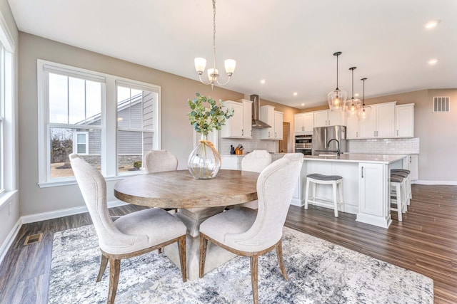 dining area featuring an inviting chandelier, dark wood-style floors, visible vents, and baseboards