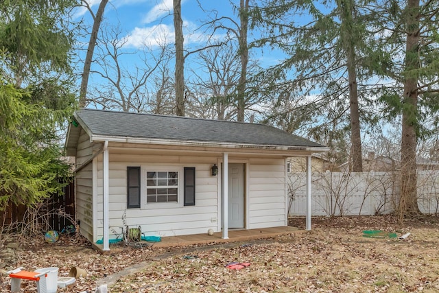 exterior space with an outbuilding and fence