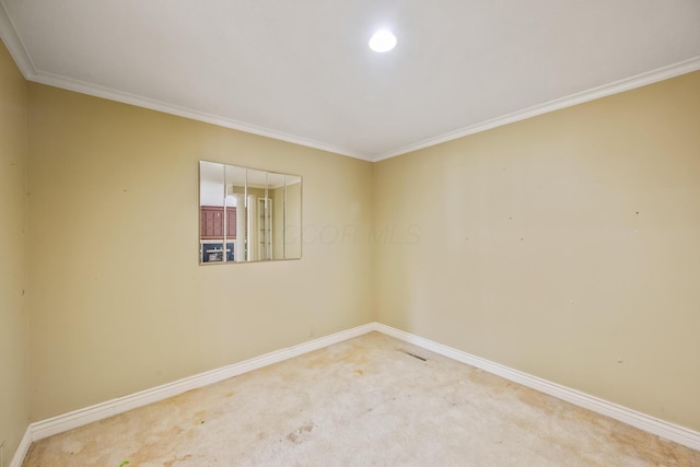 unfurnished room featuring carpet, baseboards, and ornamental molding