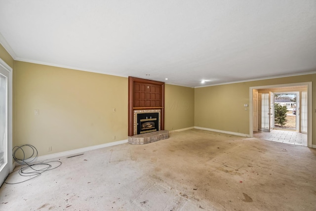 unfurnished living room featuring light colored carpet, a fireplace, crown molding, and baseboards