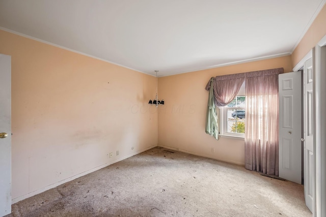 unfurnished room with carpet floors and crown molding