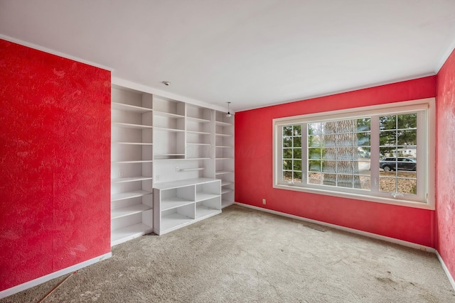 unfurnished bedroom with carpet flooring, baseboards, and visible vents