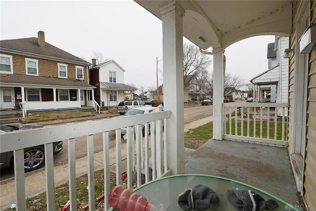 view of patio with covered porch and a residential view