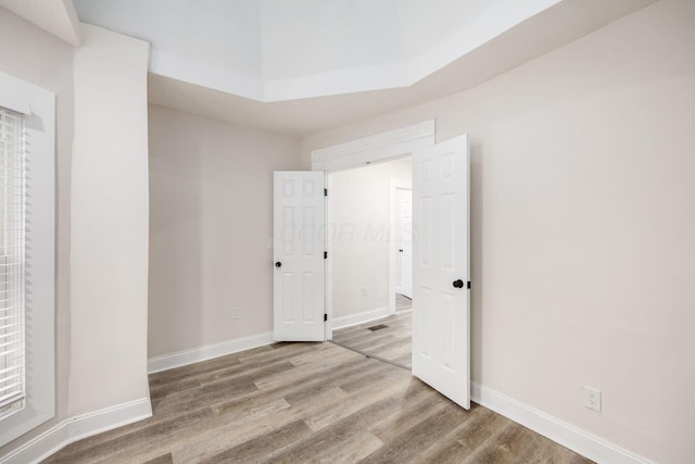 empty room with wood finished floors and baseboards