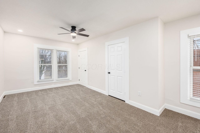 unfurnished bedroom featuring baseboards, carpet, and a ceiling fan