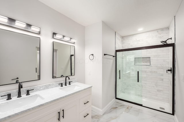 full bathroom with a shower stall, baseboards, marble finish floor, and a sink