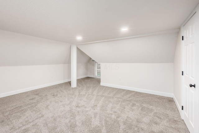 additional living space with light carpet, recessed lighting, baseboards, and vaulted ceiling