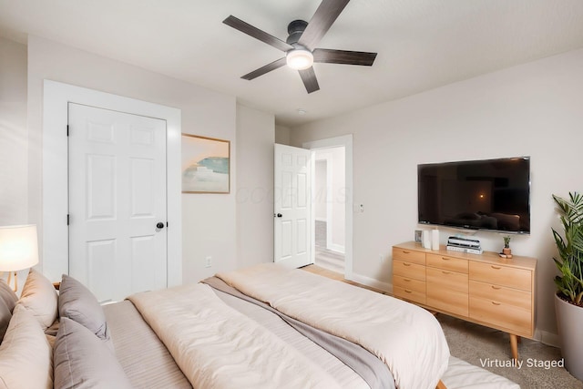 bedroom featuring baseboards, carpet floors, and a ceiling fan