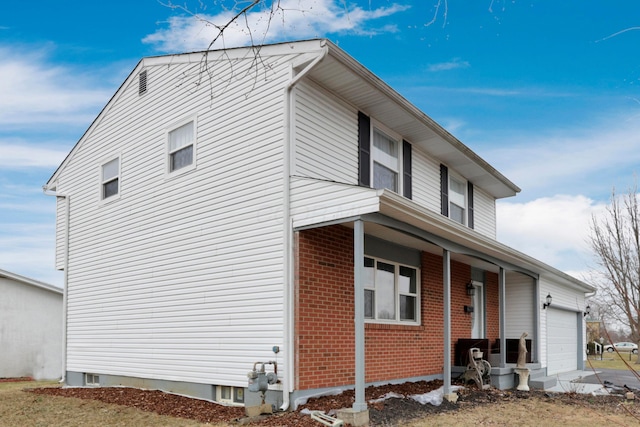 view of home's exterior featuring brick siding and a garage