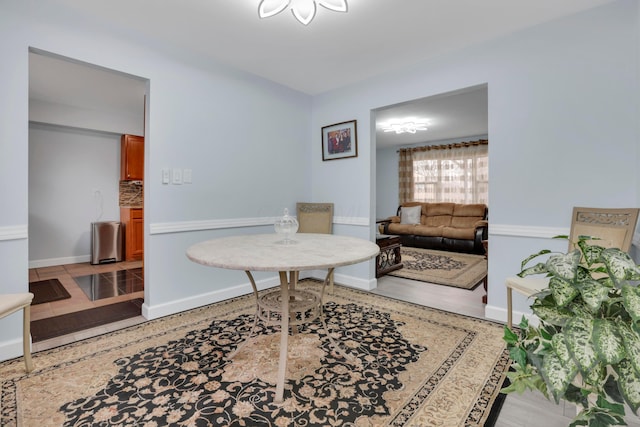 living area featuring baseboards and wood finished floors