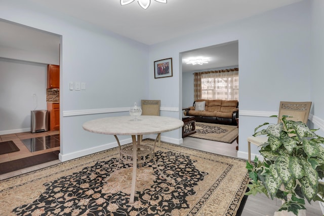 interior space with baseboards and light wood finished floors