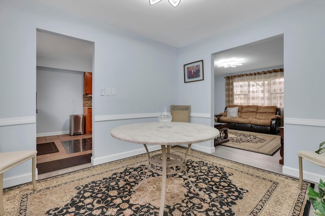 interior space with wood finished floors and baseboards