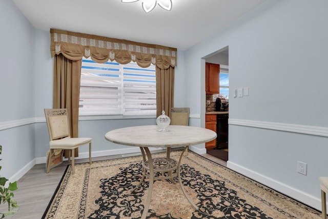 dining room with light wood-type flooring and baseboards