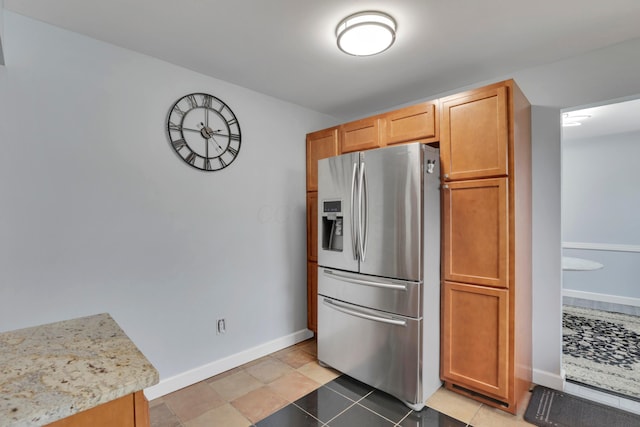 kitchen with baseboards and stainless steel refrigerator with ice dispenser