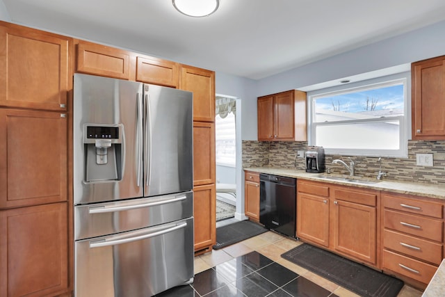 kitchen featuring black dishwasher, stainless steel refrigerator with ice dispenser, backsplash, and a sink