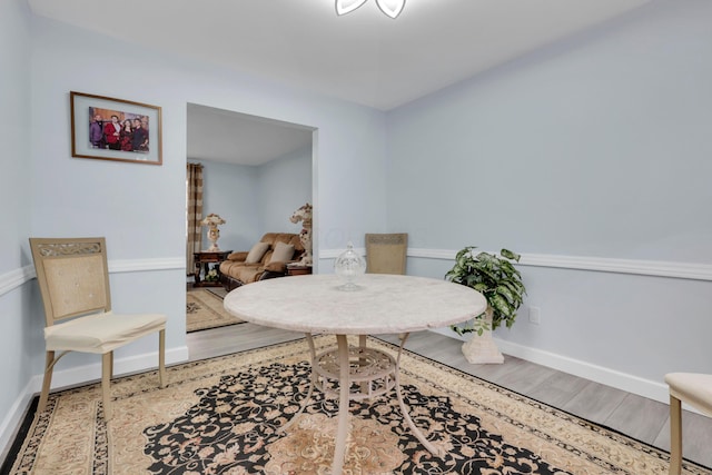 dining area featuring wood finished floors and baseboards