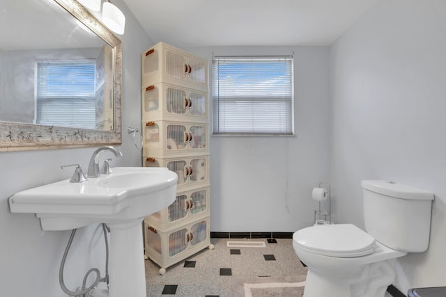 bathroom featuring toilet and baseboards