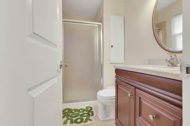 full bath with toilet, a stall shower, vanity, and tile patterned flooring