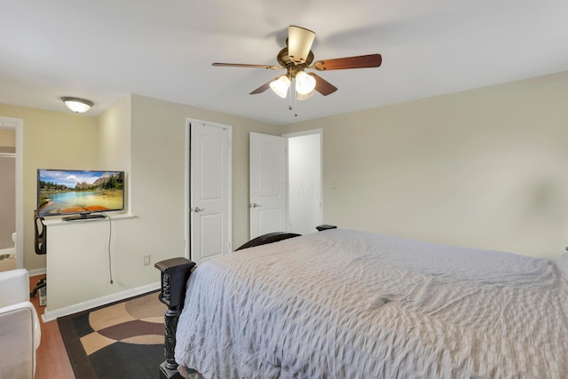 bedroom with ceiling fan, baseboards, and wood finished floors