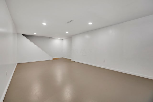 finished below grade area with visible vents, recessed lighting, and baseboards