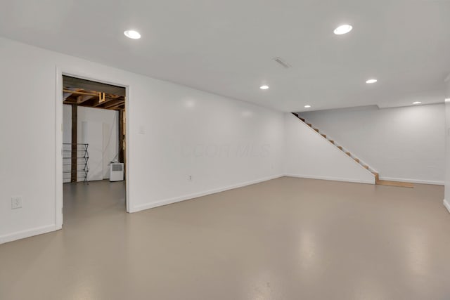 finished basement featuring stairs, recessed lighting, and baseboards