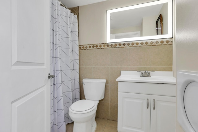 full bath featuring vanity, a shower with shower curtain, tile walls, toilet, and tile patterned floors