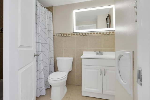 full bathroom featuring vanity, tile patterned flooring, curtained shower, tile walls, and toilet