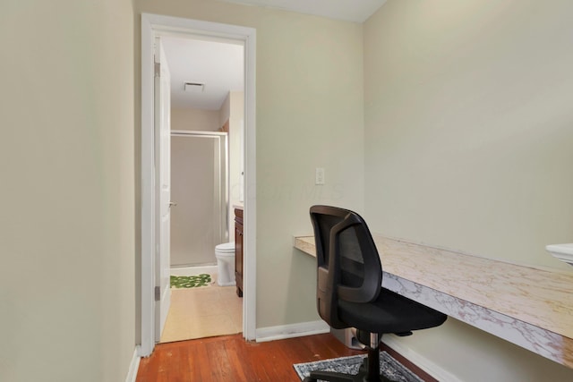 office space with visible vents, baseboards, and wood finished floors