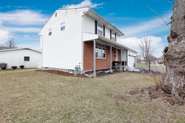 view of property exterior featuring a yard, brick siding, and a garage