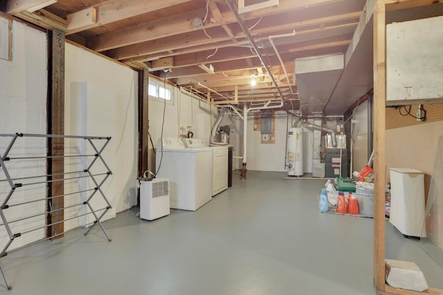 basement with heating unit, separate washer and dryer, and water heater