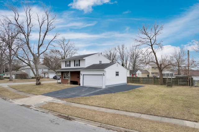 view of front of home featuring driveway, a front lawn, fence, a residential view, and a garage