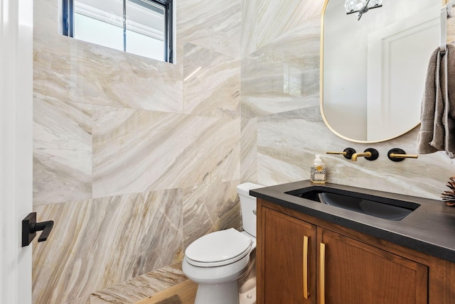 half bathroom with toilet, tile walls, and vanity