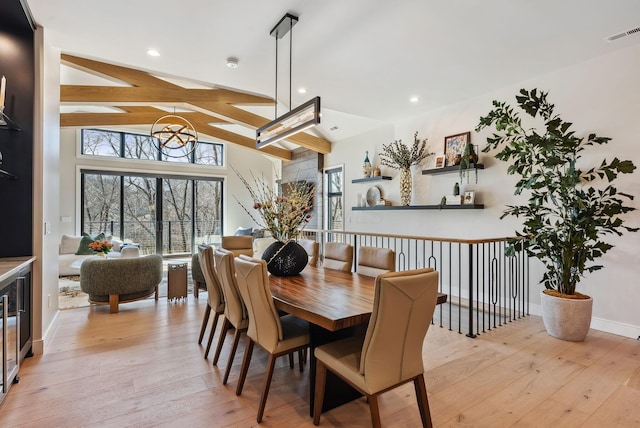 dining room with visible vents, recessed lighting, light wood-style floors, baseboards, and vaulted ceiling with beams