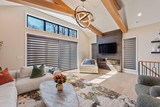 living room featuring beamed ceiling, visible vents, a notable chandelier, high vaulted ceiling, and wood finished floors