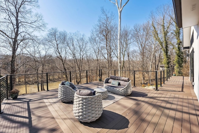 wooden terrace featuring outdoor lounge area and visible vents