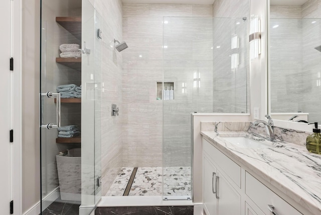 full bath featuring vanity and a shower stall