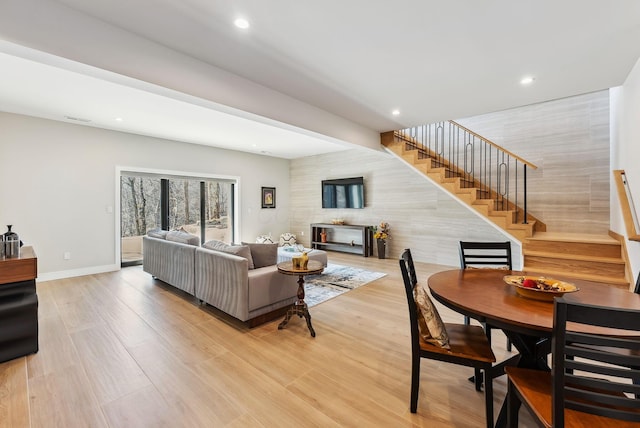 living area with visible vents, recessed lighting, stairs, and baseboards