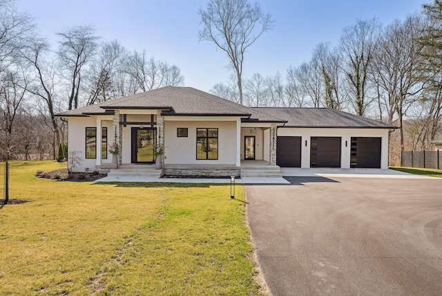 view of front of home featuring fence, an attached garage, stucco siding, a front lawn, and concrete driveway