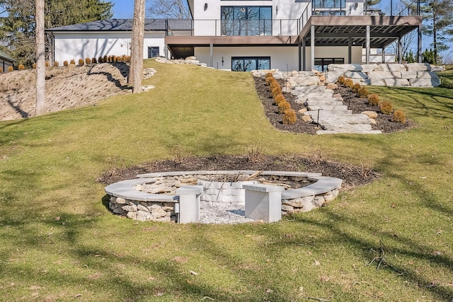 view of yard featuring a wooden deck and an outdoor fire pit