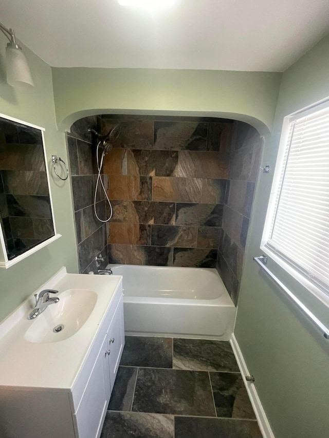 full bath featuring vanity, shower / bathtub combination, and baseboards