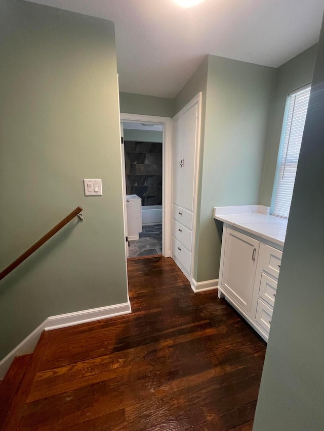 interior space with dark wood finished floors and baseboards