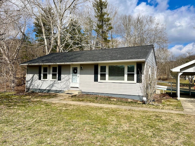 view of front of property with a carport and a front yard