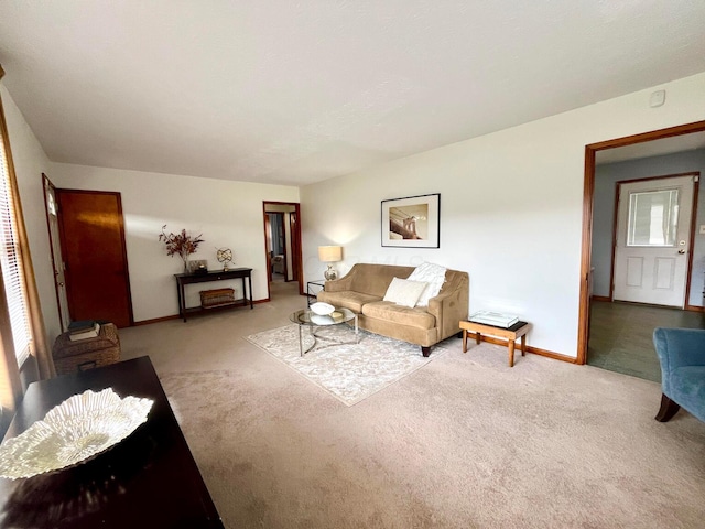 carpeted living area featuring baseboards