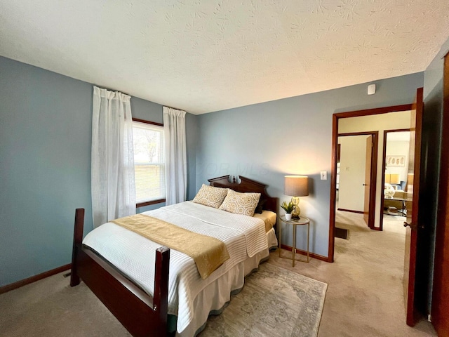 carpeted bedroom featuring a textured ceiling and baseboards