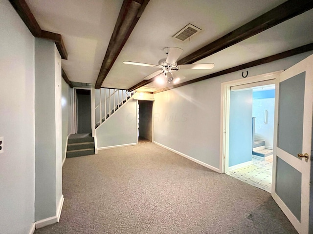 basement featuring stairway, a ceiling fan, baseboards, visible vents, and carpet floors