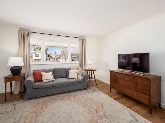 living area with baseboards and wood finished floors