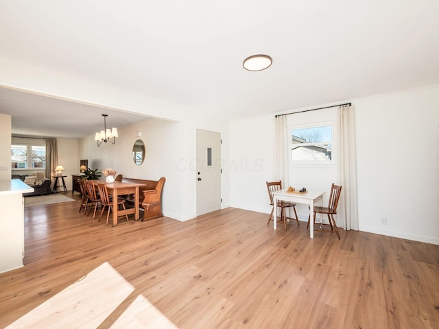 dining area featuring a chandelier and light wood-style flooring