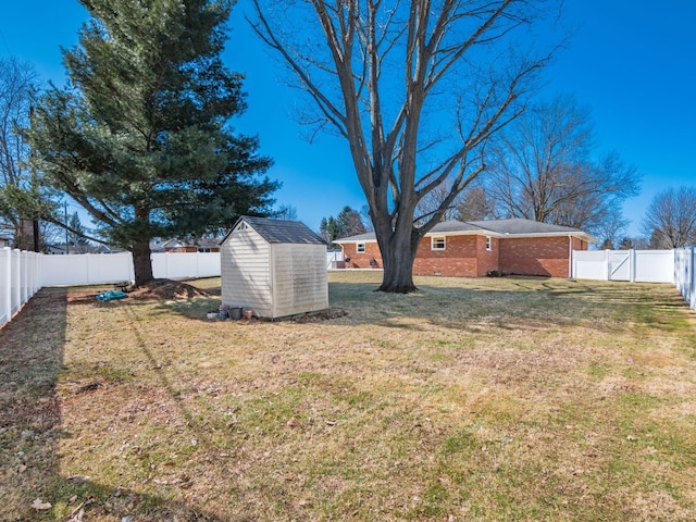 view of yard featuring an outbuilding, a fenced backyard, and a shed